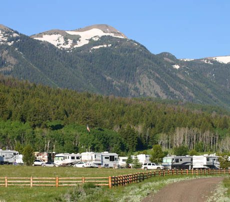 RV's parked near a mountain forest